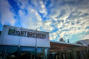 The front exterior of Bright Brewery with a beautiful blue and cloudy sky
